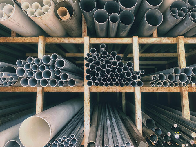 PVC and steel pipe on a shelf in a pluming supply warehouse