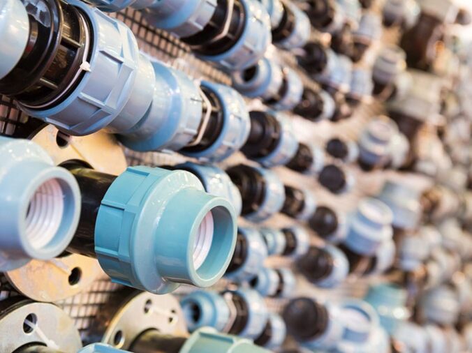 PVC pipe unions on the wall in a plumbing supply store